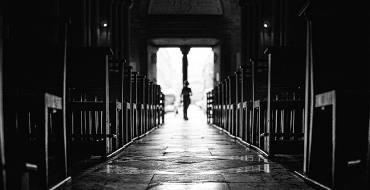 view down the center aisle between rows of pews