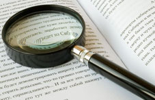 Magnifying glass on open book