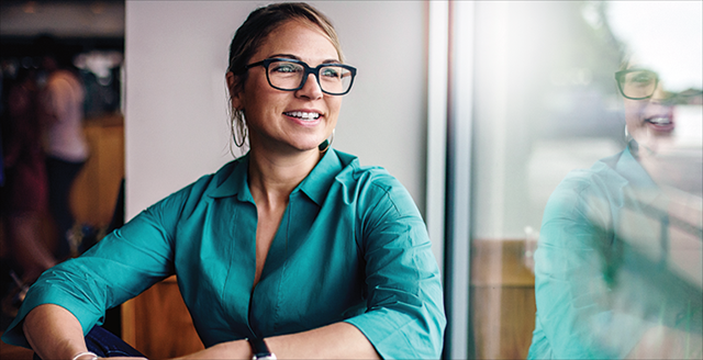 Image of Dr. Jennifer Romano-Bergstrom smiling by a window