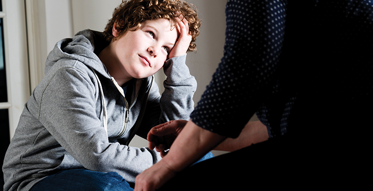 young boy listening to a therapist