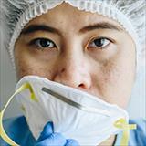 health care worker with medical mask looking very tired