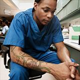 health care working in scrubs sitting in a chair