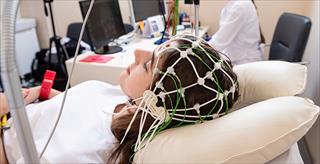 woman wearing a sleep monitor on her head