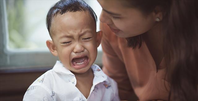 child crying with a mother trying to calm