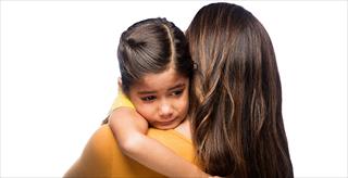 child crying on mother's shoulder