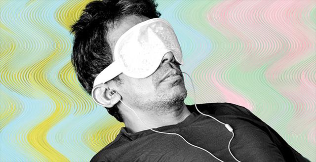 person wearing headphones and an eye mask