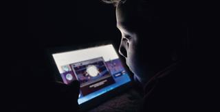 child looking at a computer scrren