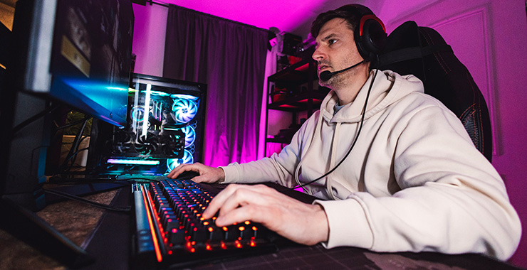 adult man wearing a headset and playing video game