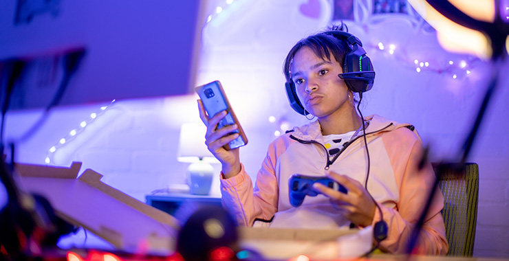 teen with phone and gaming headset