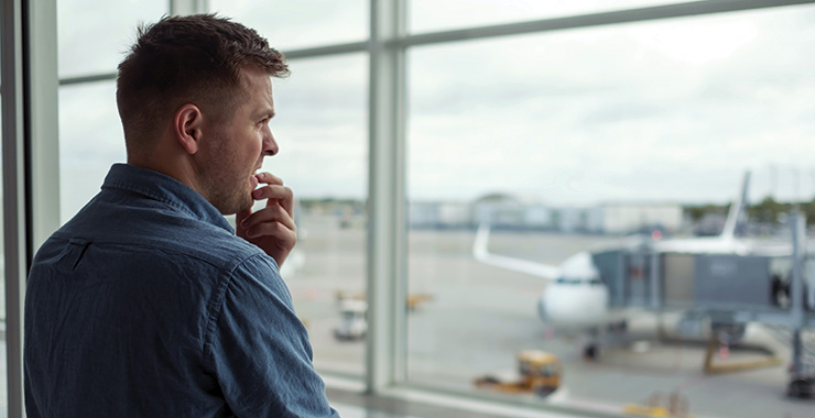 man looking worried at an airport