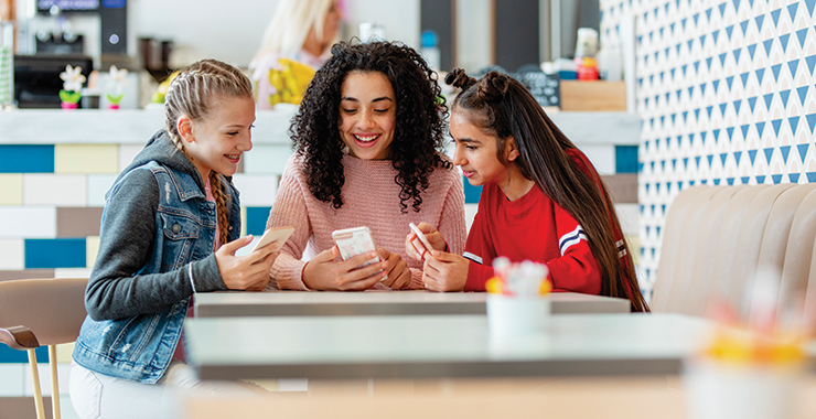 three girls with smartphones