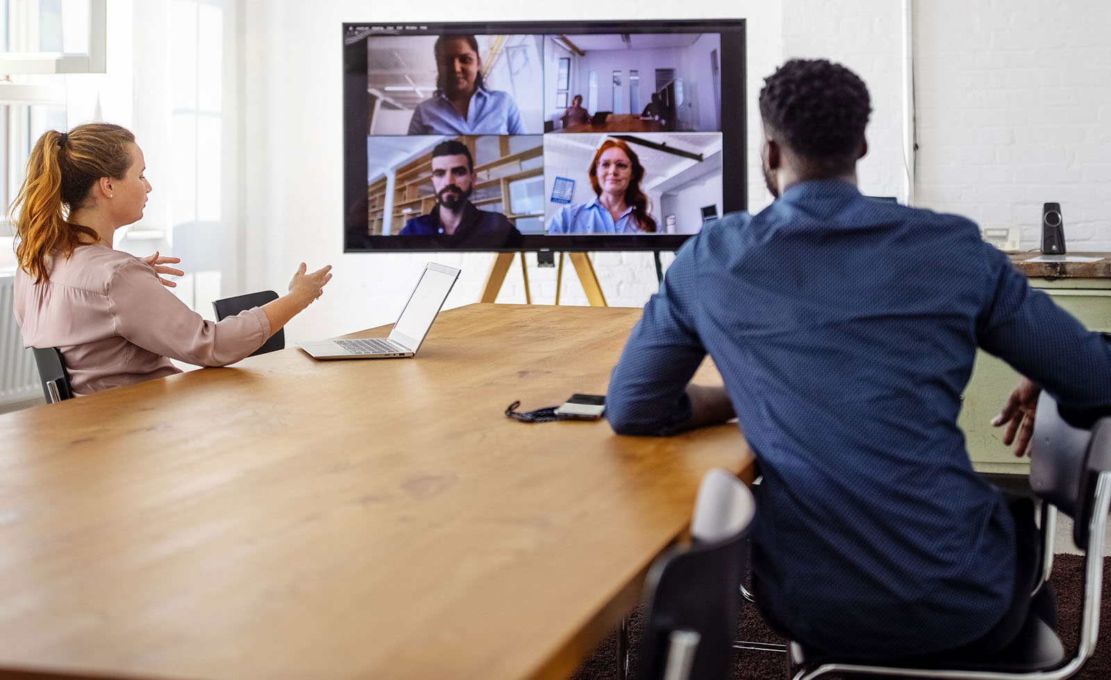 employees attending a hybrid meeting