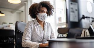 Black female employee working in home office