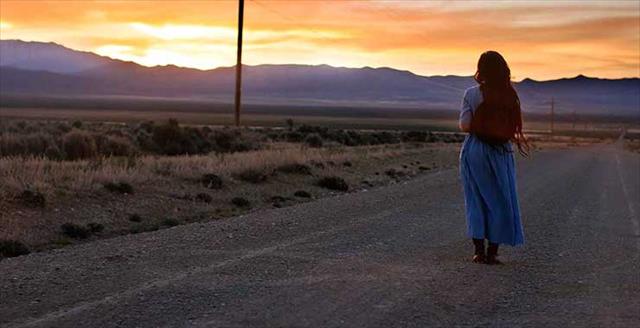 woman walking along rural road