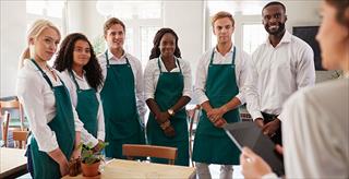 group of restaurant staff wearing aprons