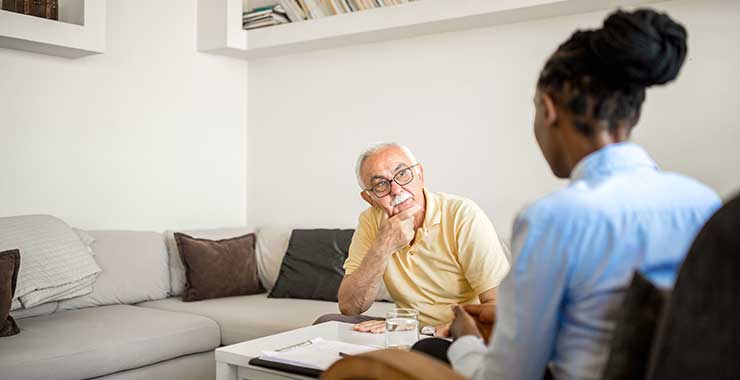 therapist and older adult man during session