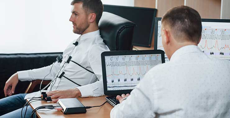 man hooked up to a polygraph machine