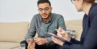 young man discussing issues with a therapist