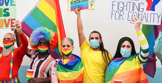 Multiracial group in masks at an LGBTQ Pride event