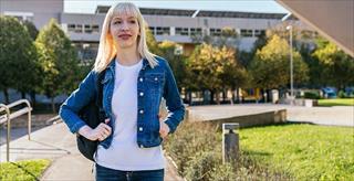 Transgender student standing on campus