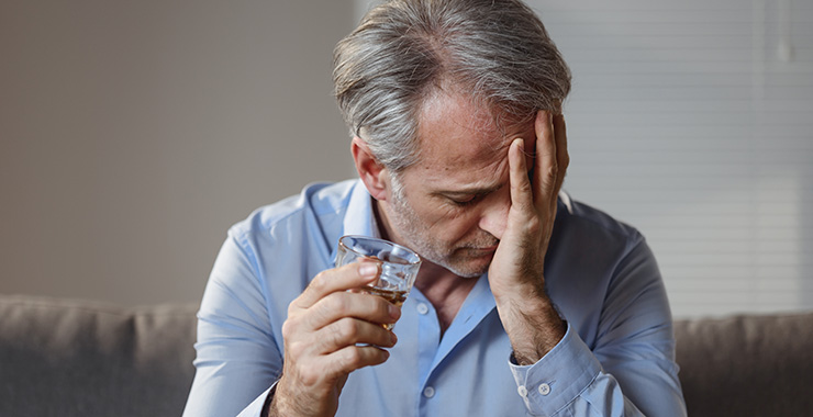 distressed man drinking alcohol